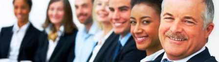 Smiling business people seated in a row