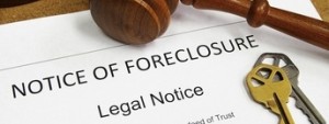 Foreclosure document with house keys and gavel